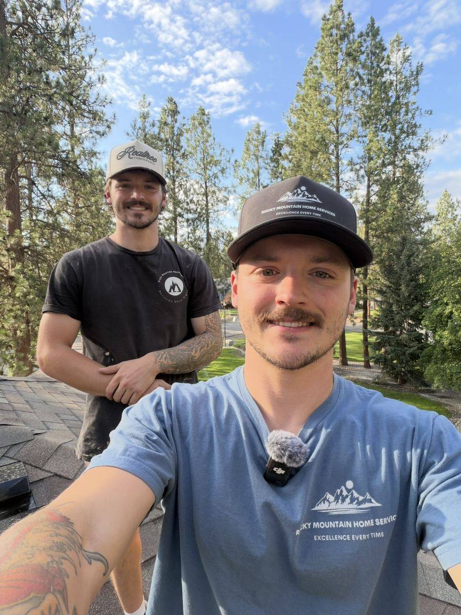 Sean and Drake Wilson on a roof in North Idaho