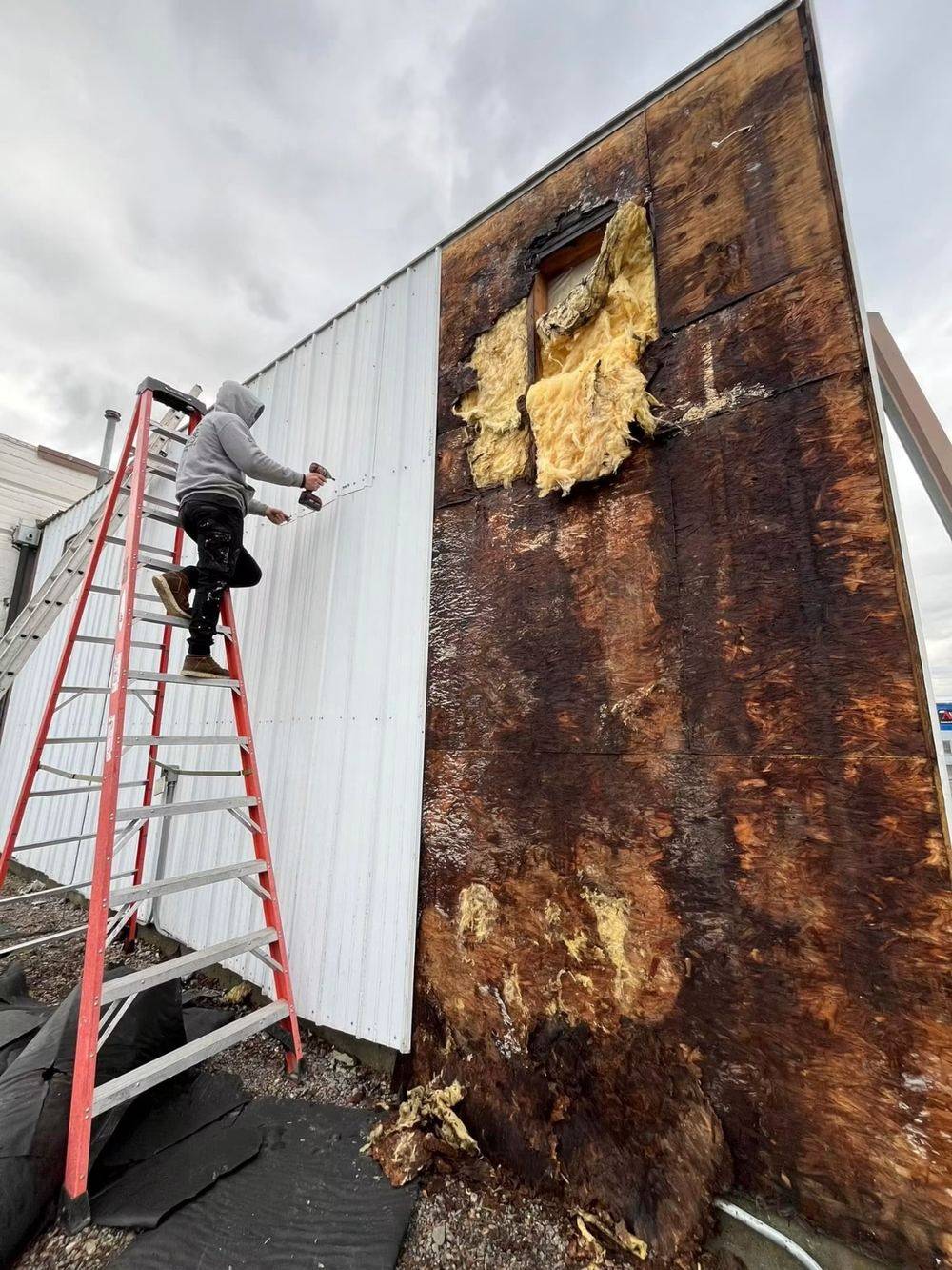 Repairing rotted, water-damaged siding on a building