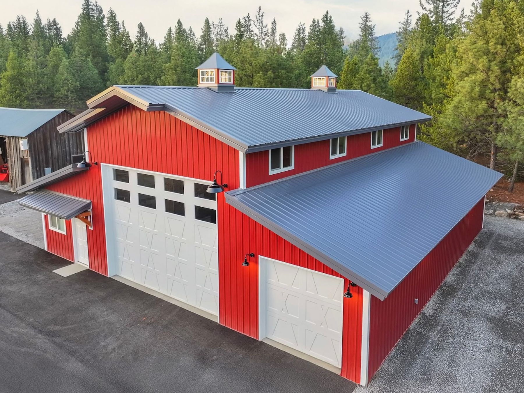 Red barn with standing-seam metal roof built by Rocky Mountain Home Services in North Idaho