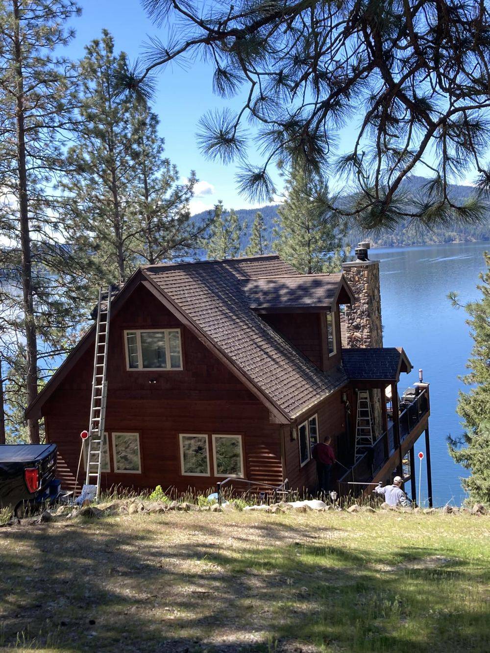 Roof cleaning and moss removal on a lakeside cabin in North Idaho