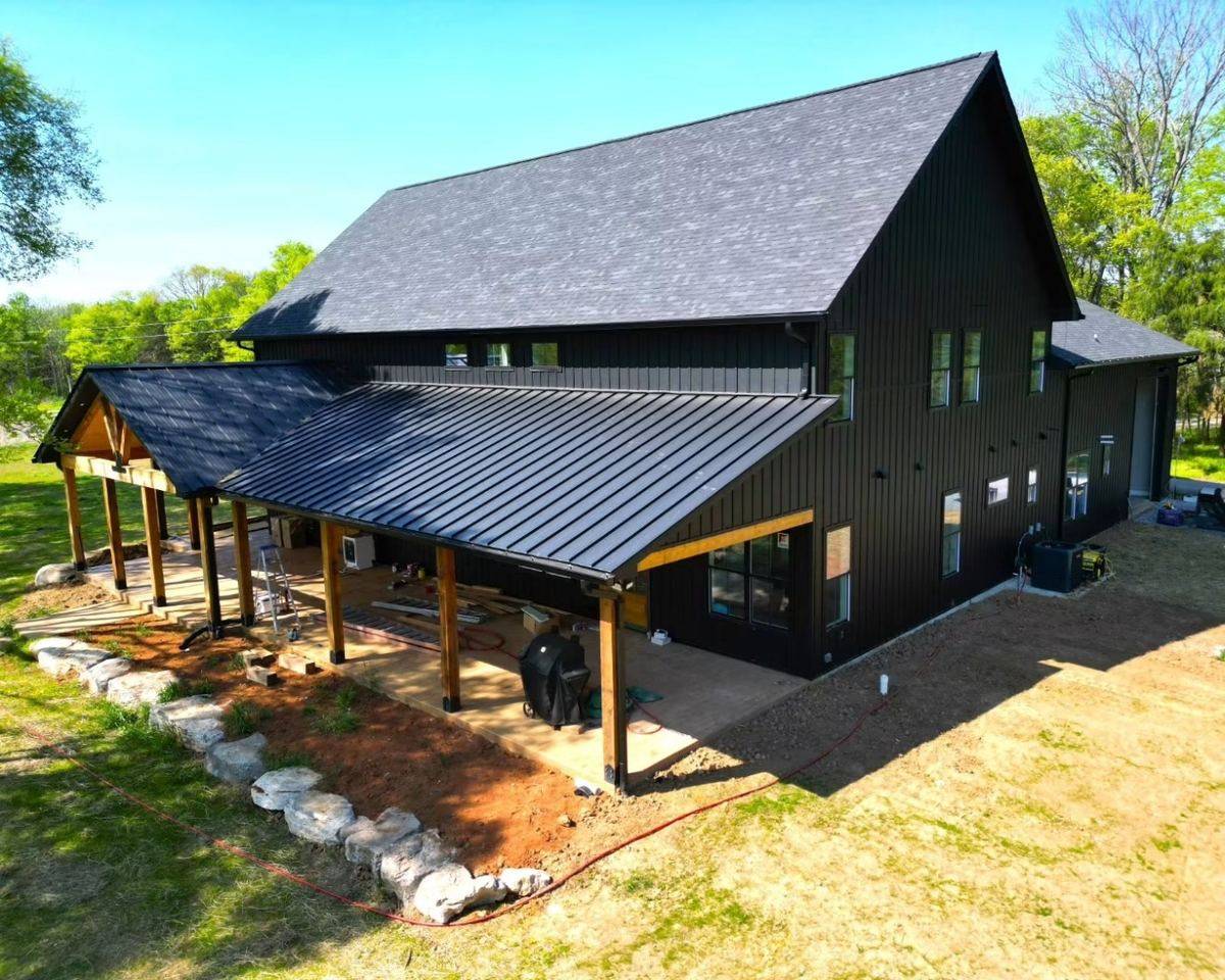 Barndominium with standing-seam metal roof and covered porch